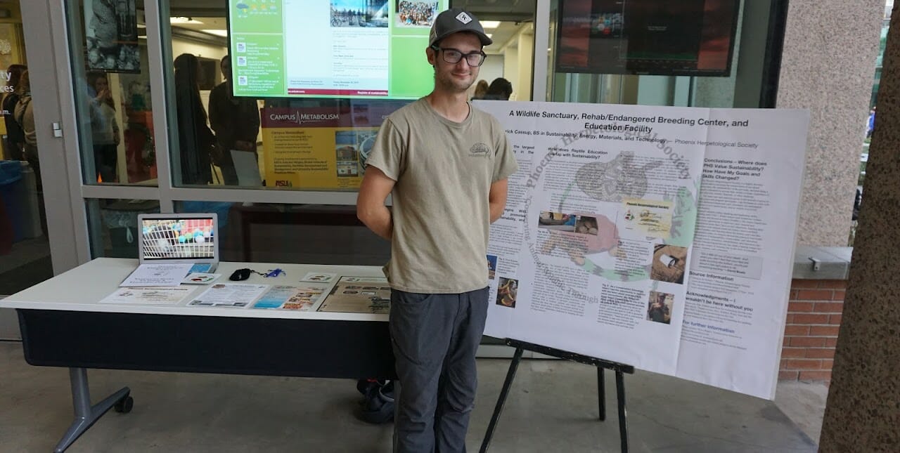 Student standing by a poster