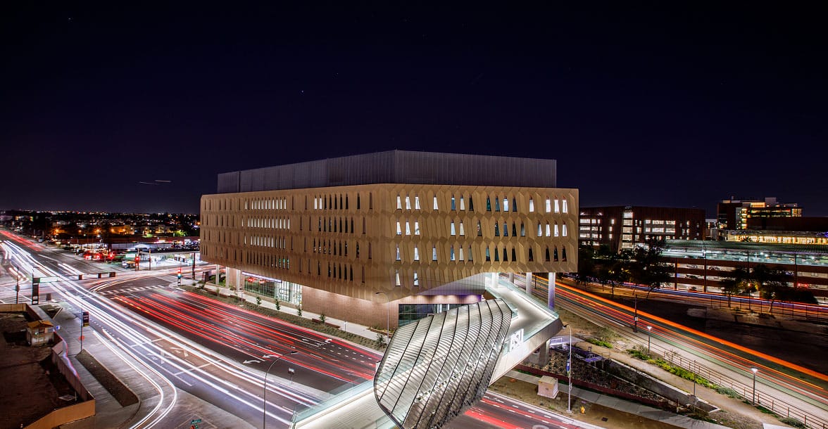 Exterior of the College of Global Futures building at ASU, featuring modern glass architecture and desert landscaping.