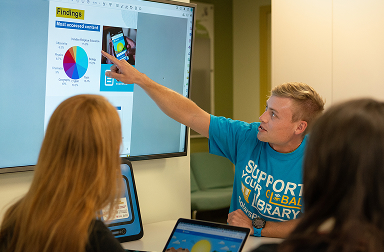 ASU student sharing findings through a project with SolarSPELL